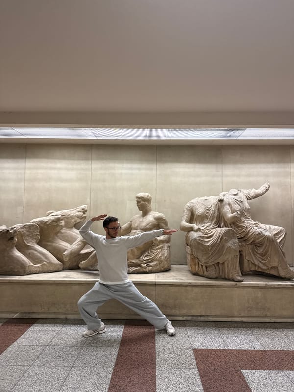 Tourist leaps near ancient sculptures at Athens Acropolis Museum