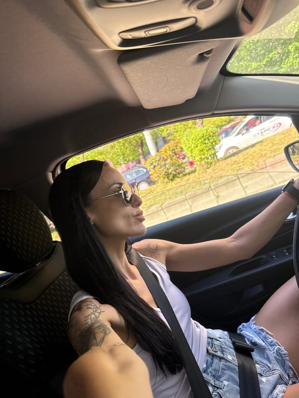 Woman in sunglasses observed seated in car in Pleven