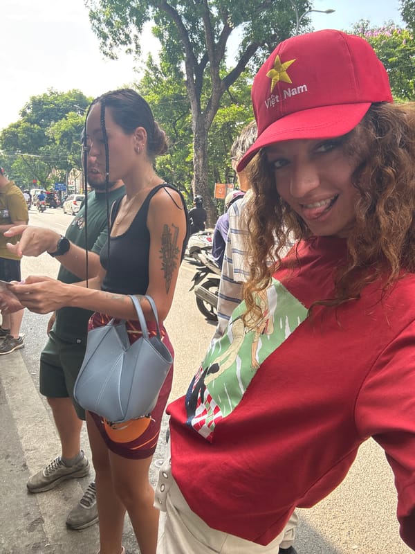 Woman in Vietnamese cap photographed smiling in Hanoi