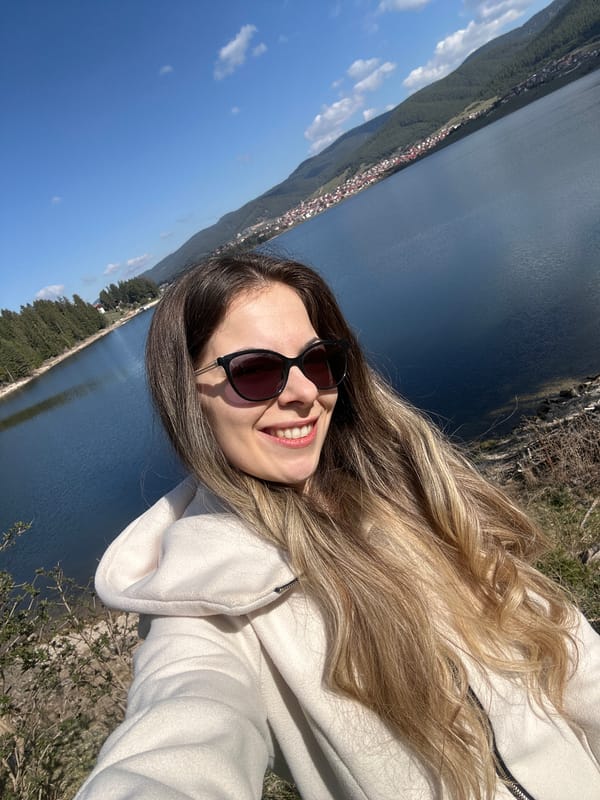 Woman poses for photos at Lake Dospat, Bulgaria