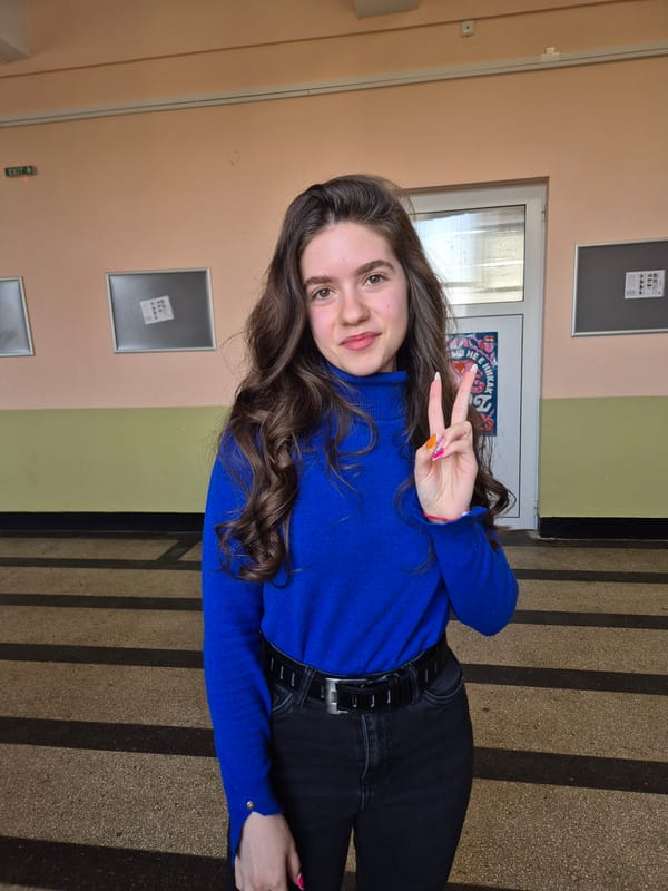 Woman makes peace sign in Pavlikeni hallway