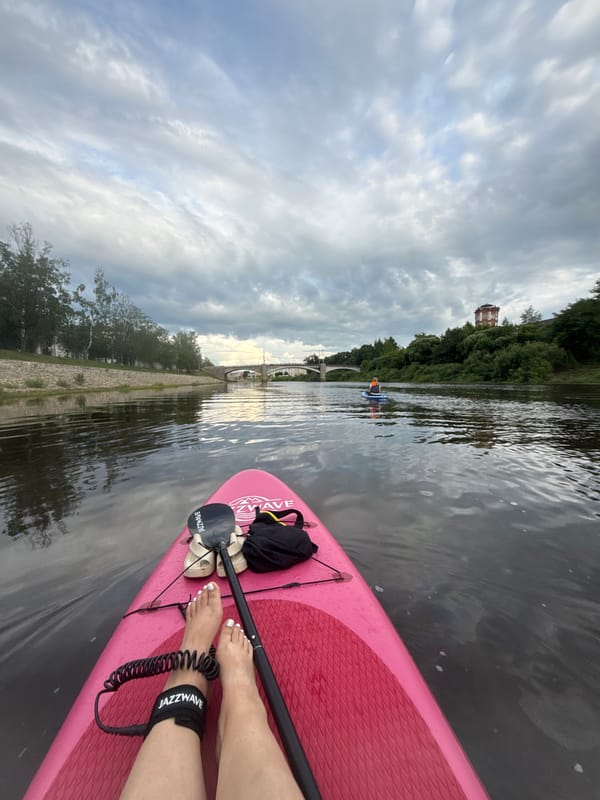 Paddleboarding past historic riverfront architecture on the Vologda River