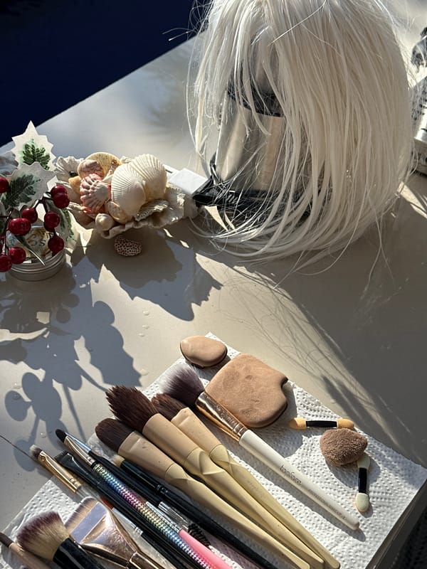Makeup tools and a blonde wig laid out in North Kuta