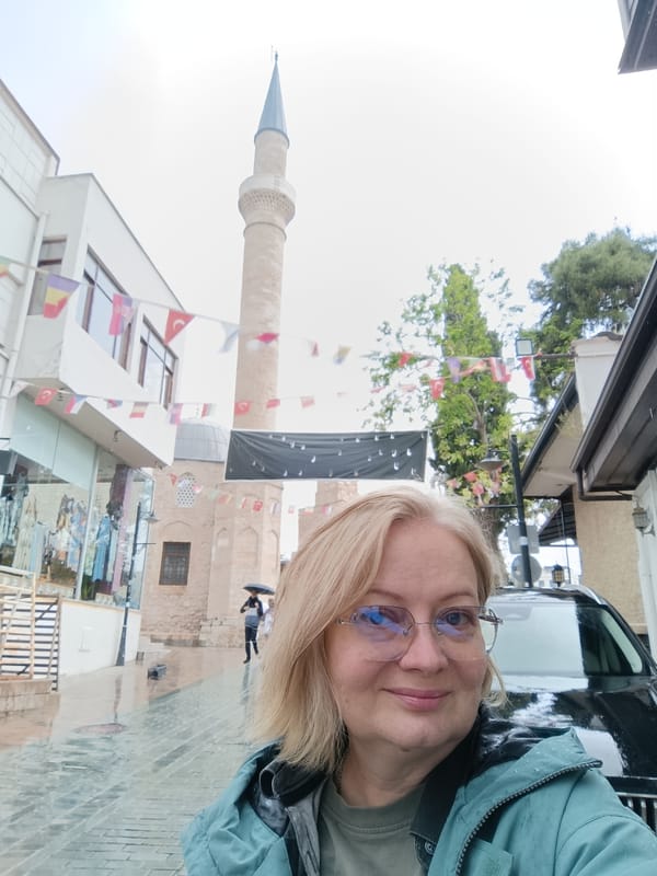 Tourist documents rainy afternoon stroll through historic Antalya district