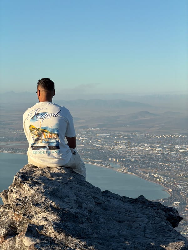 Cape Town mountain viewpoint draws contemplative visitors, paraglider overhead