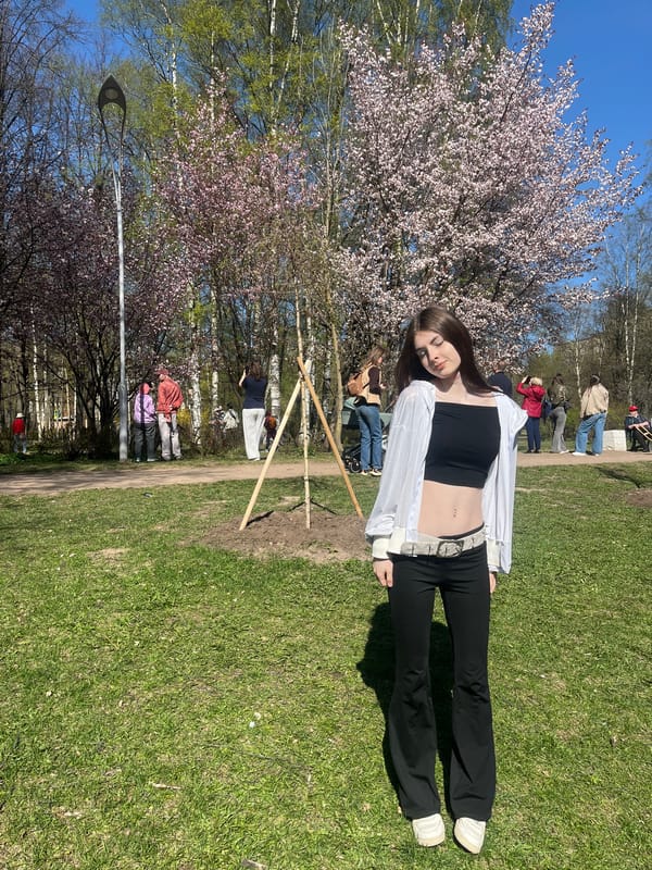 Spring gathering under blooming trees captured by park visitors