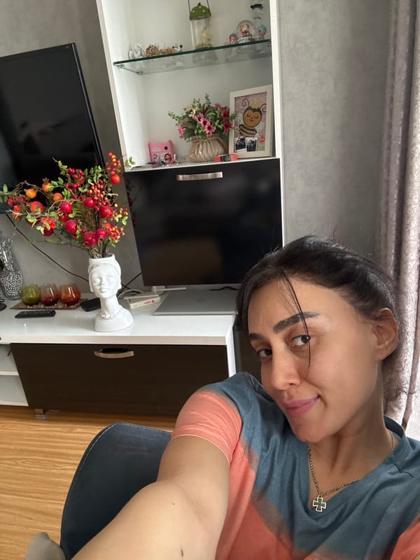Woman takes indoor selfies near window in Tbilisi