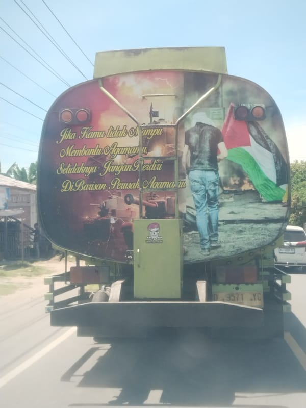 Green tanker truck displays Palestinian flag mural in Aceh