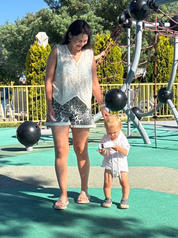 Toddler plays at sunny Sochi playground near waterfront