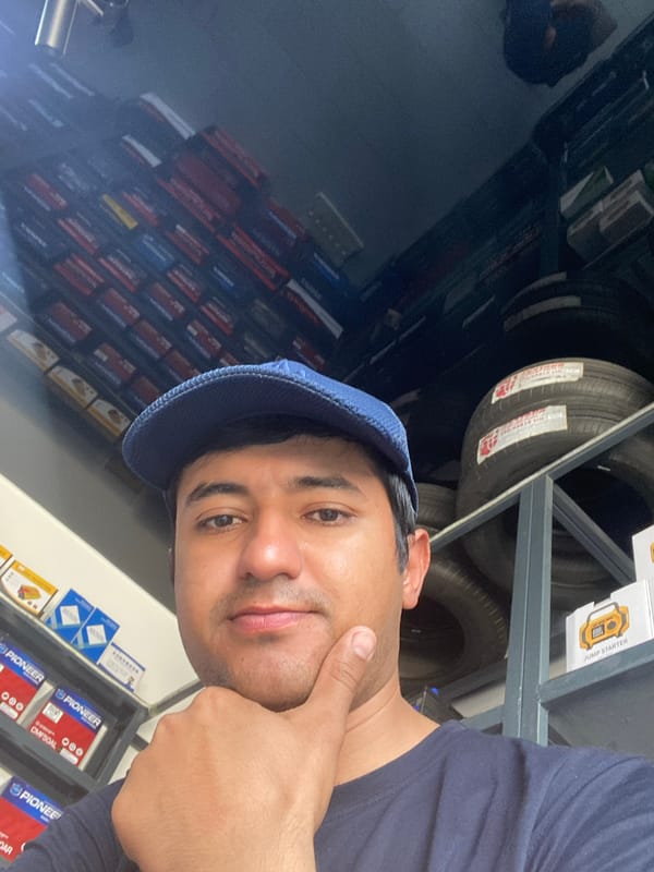 Man takes selfies in Bukhara automotive parts store