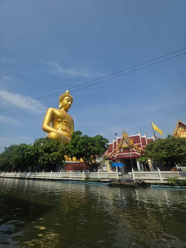 Early morning longtail boat activity near Bangkok temple district