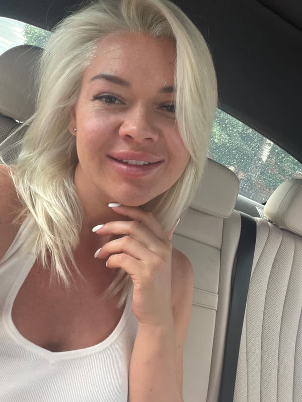 Woman in white tank top observed in car backseat