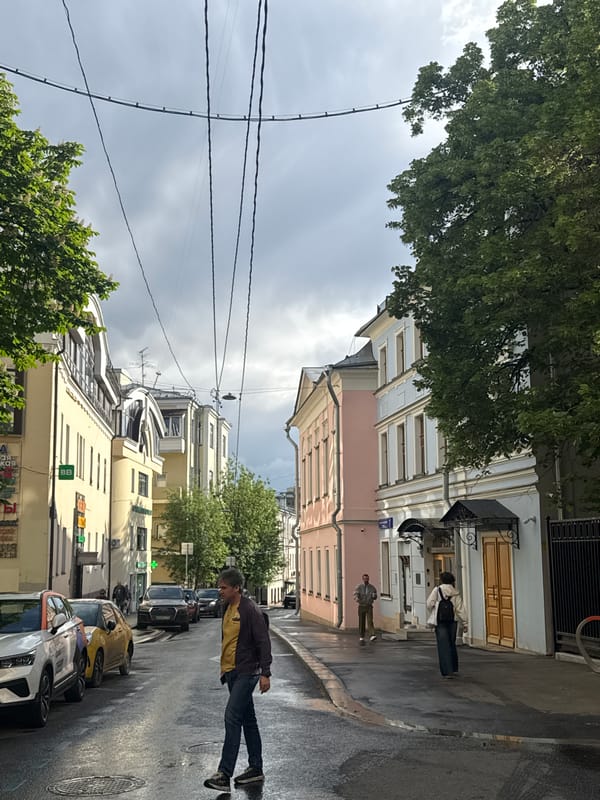 Moscow street scene shows recent rain, colorful buildings