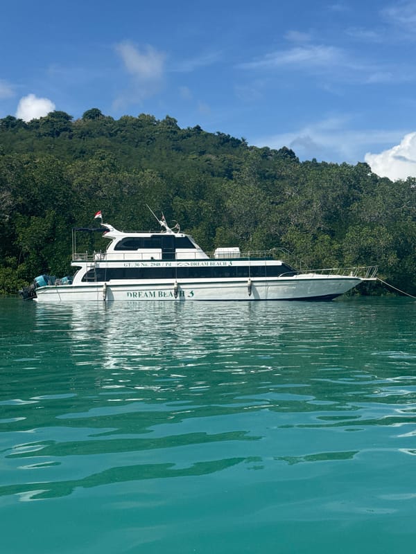 Boats navigate turquoise waters near Nusa Penida coastline