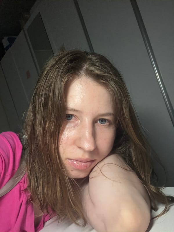 Selfie session in a dim Dongducheon room, mirror and desk in frame