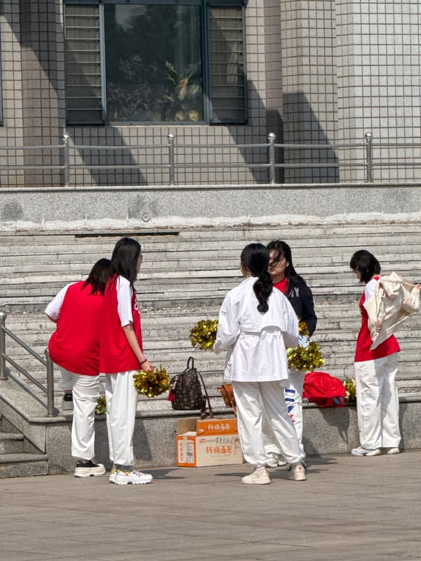 Morning life documented in Zhongtun: cheerleaders, commuters, spring blossoms