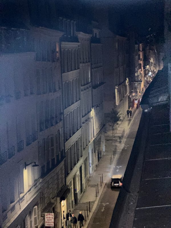 Nighttime street life and partial eclipse observed in Paris