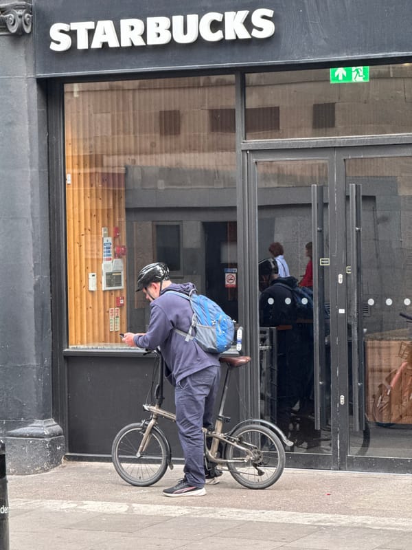 Quick phone check mid-ride with a folding bike in London