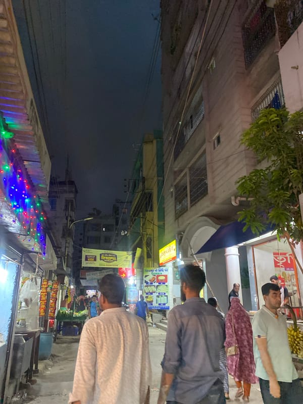 Evening street scene with colorful lights observed in Dhaka