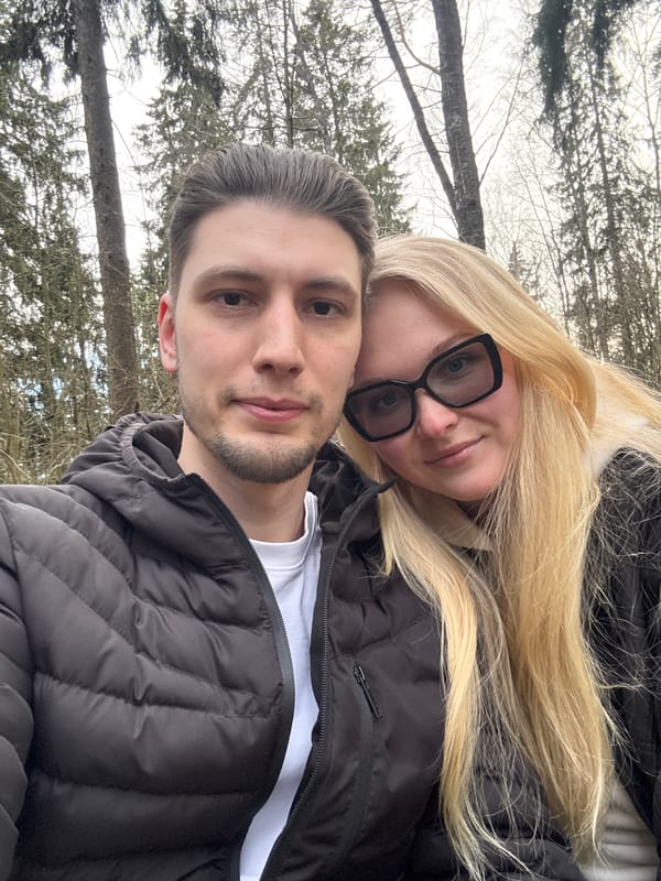 Couple documents afternoon forest hike in Toksovo, Russia