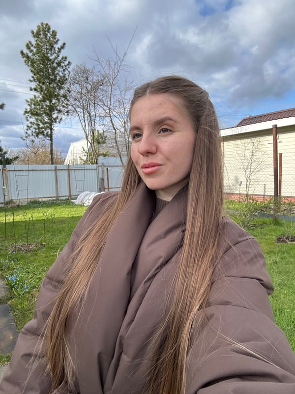 Woman takes selfies outdoors in Klin, Russia with toddler