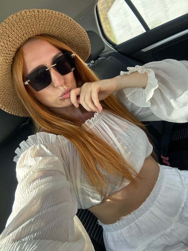 Woman takes selfie in vehicle passenger seat in Budva