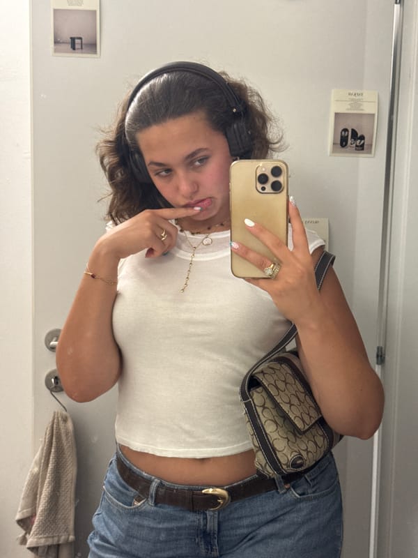 Mirror selfie session in a Milan fitting room, July 2026