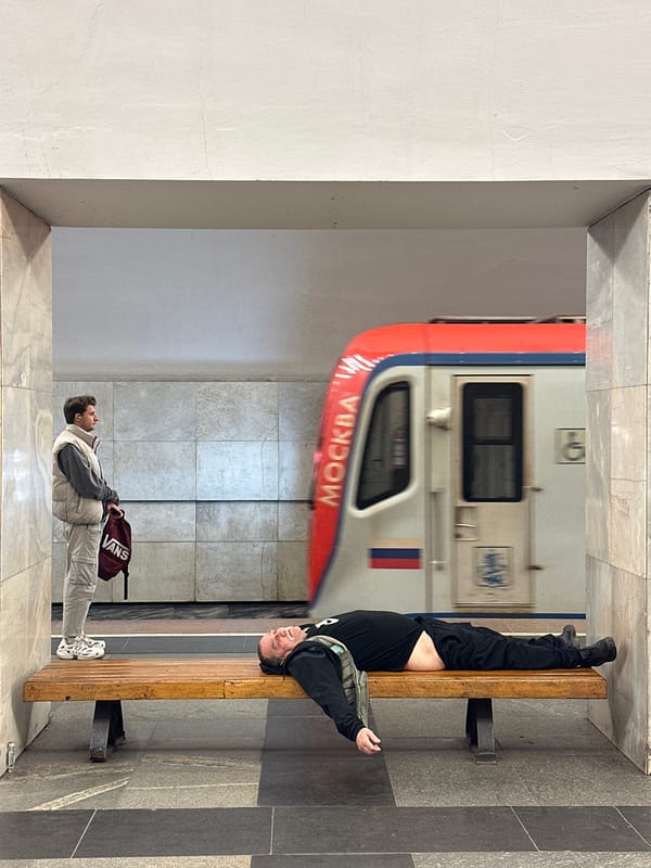 Person resting on bench at Moscow metro station
