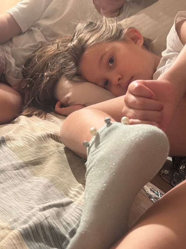 Children rest on bedspread in Krasnoyarsk home