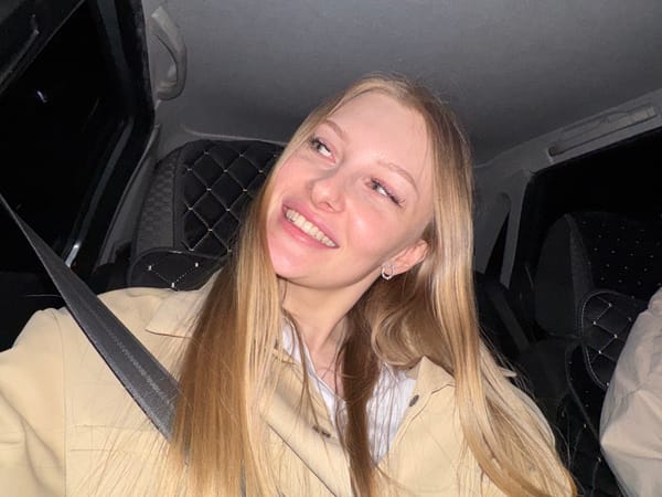 Woman photographed smiling inside car in Perm, Russia