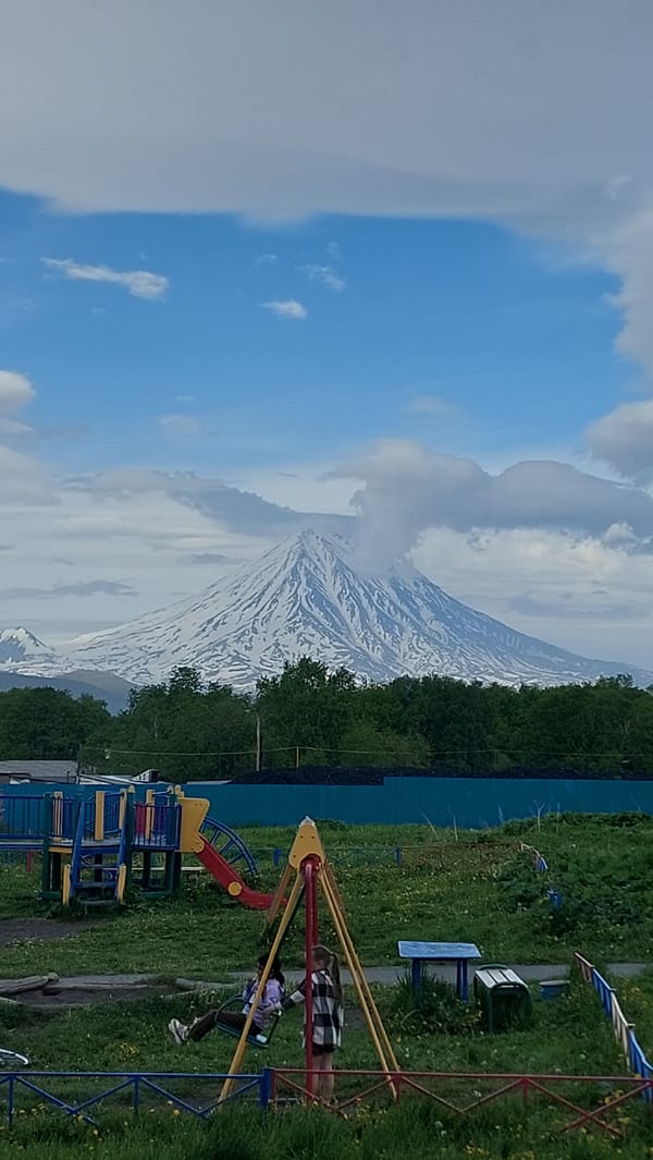 Neighborhood playground backed by volcanoes, Зелёный, Russia