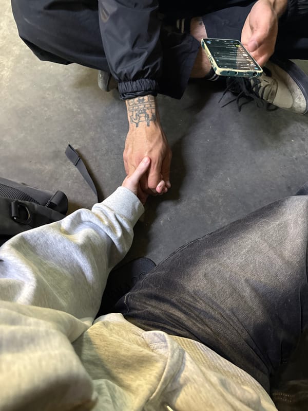 Two people seated on floor in Ramat Gan