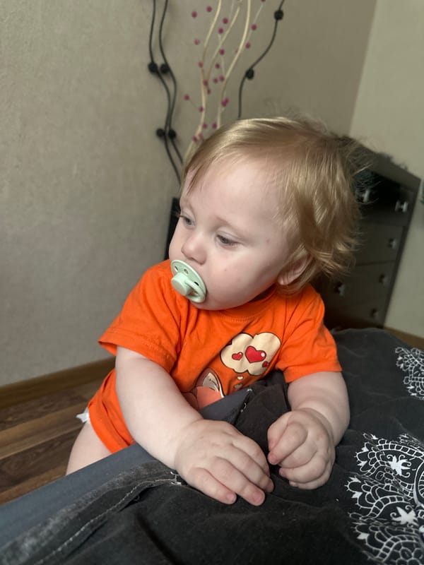 Toddler and poodle share a quiet morning in a Sayanogorsk apartment