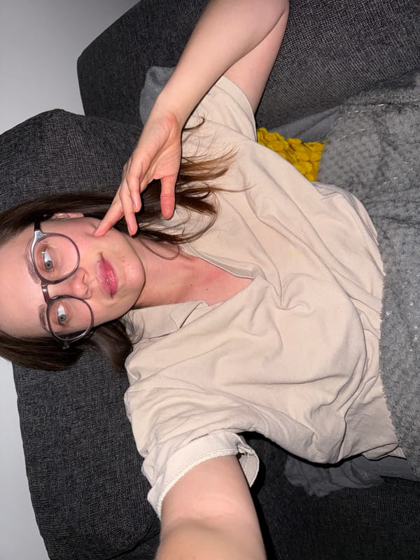 Woman relaxes on sofa while watching TV in Hungarian lakeside town