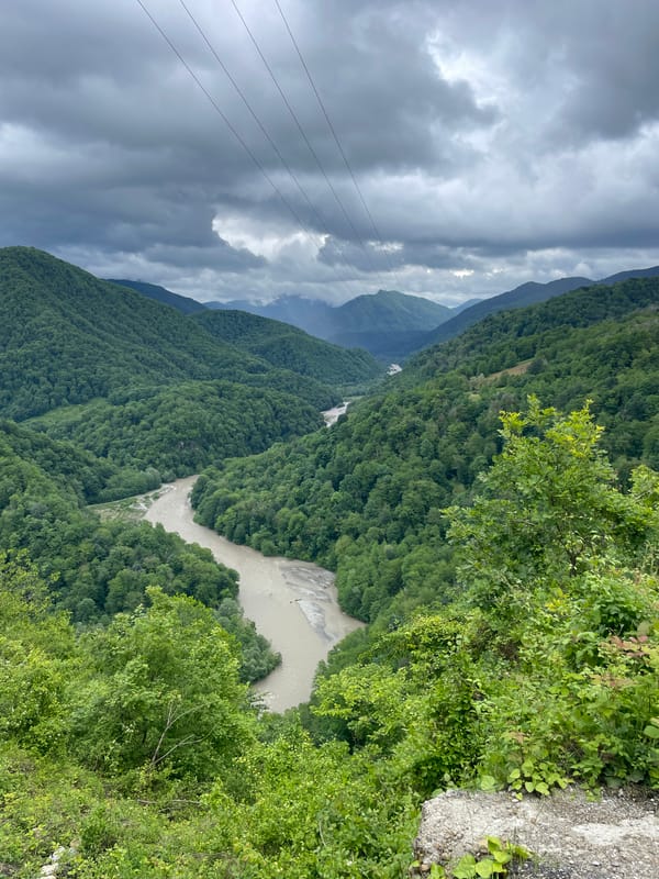 Tourist documents mountain adventure at Russian scenic viewpoint