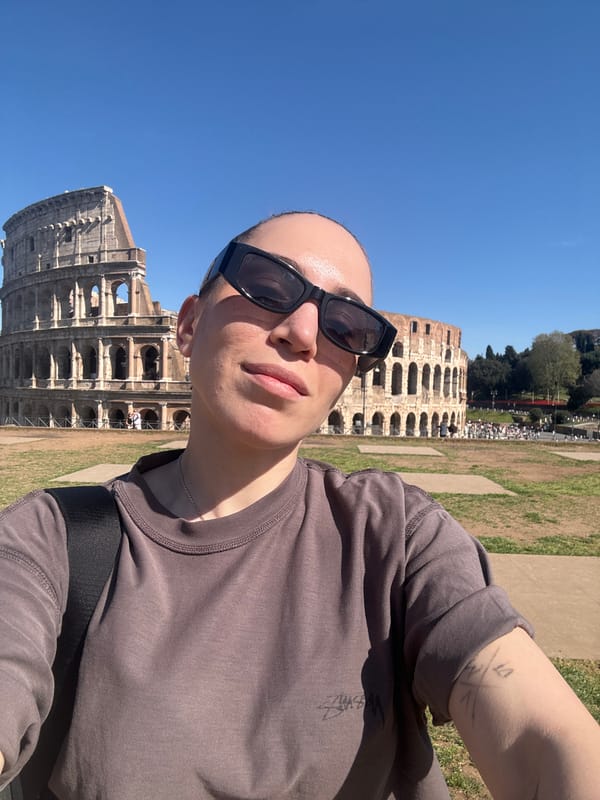 Tourist photographs and rests at Rome's Colosseum