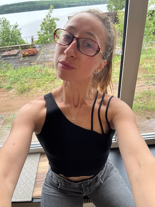 Woman takes selfies in office space in Chaikovsky, Russia