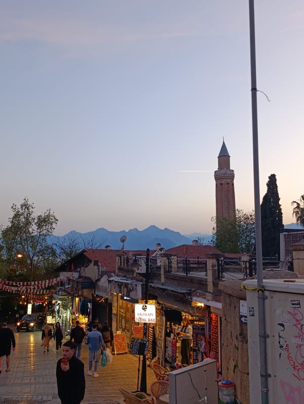 Tourist documents evening walk through historic Antalya, Turkey