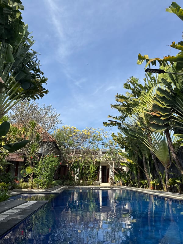 Monitor lizards and tropical flora at a Bali resort pool