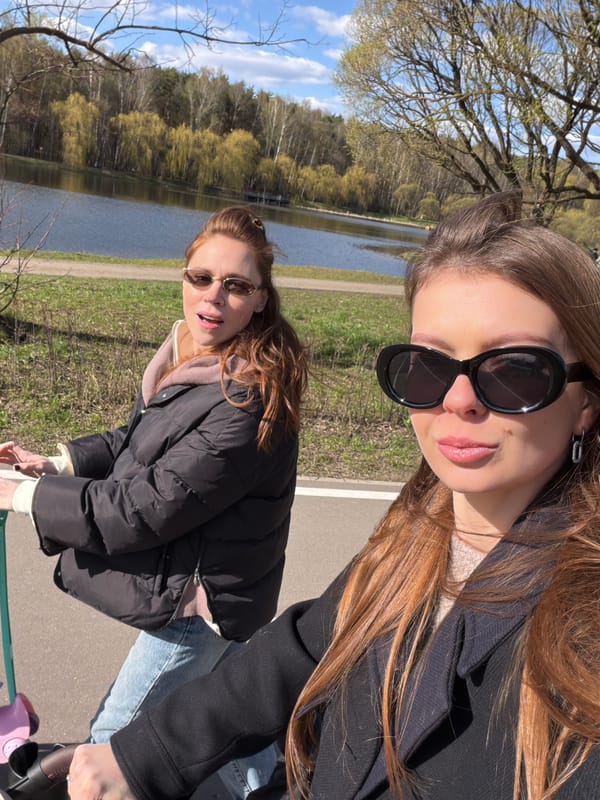 Women pose for photos in Moscow park during spring day