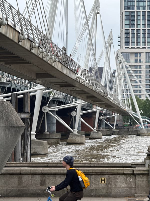 Tourist documents London landmarks walk near Thames bridges