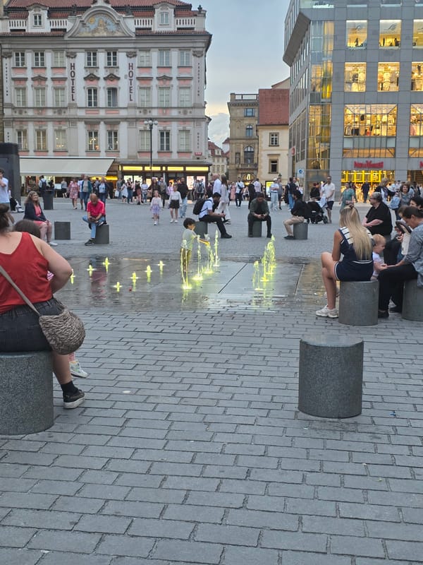 Evening urban life documented around Franz Kafka sculpture location