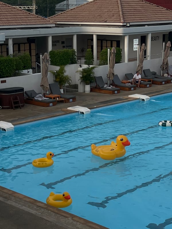 Person reads tablet outdoors in Kathu, Thailand