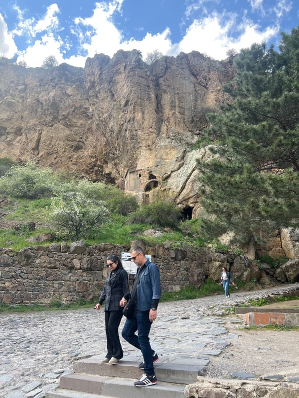 Tourists explore historic Geghard Monastery complex in Armenia