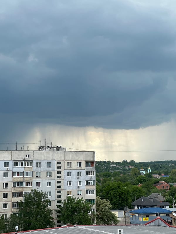 Dramatic storm clouds contrast with clear sky over urban area