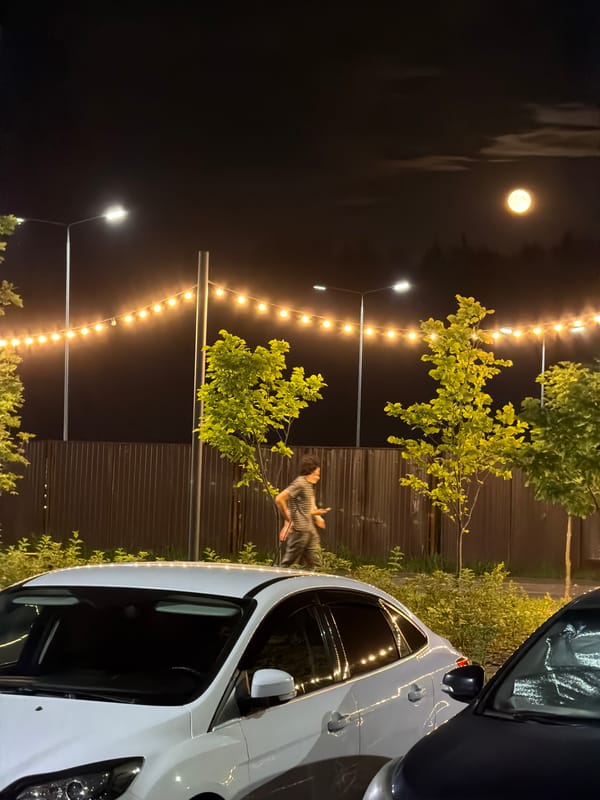Full moon night at a Russian apartment complex parking lot