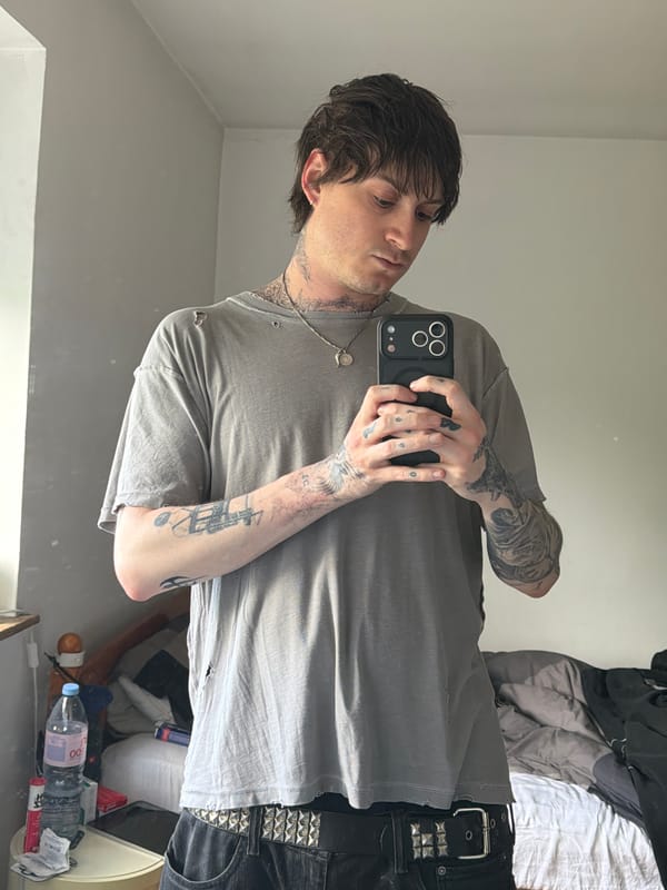 Young man takes mirror selfie in London room