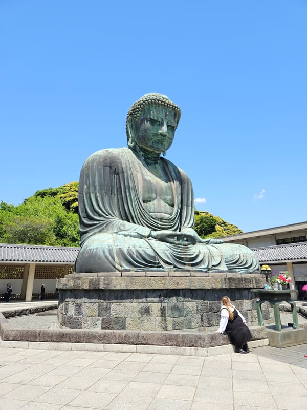 Visitor photographs iconic Great Buddha statue in Kamakura