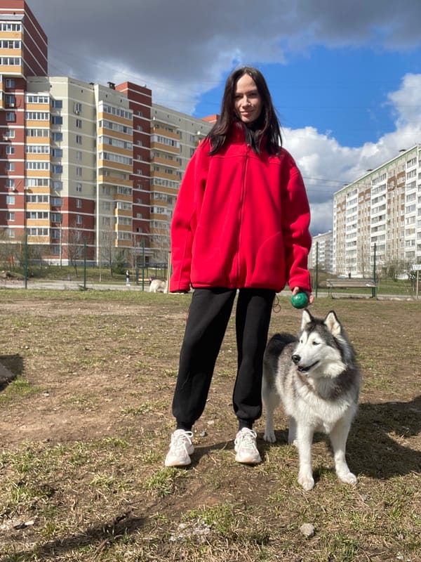 Woman plays with husky dog in Izhevsk park
