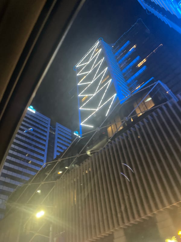 Night drive captures modern Sofia building reflection on windshield